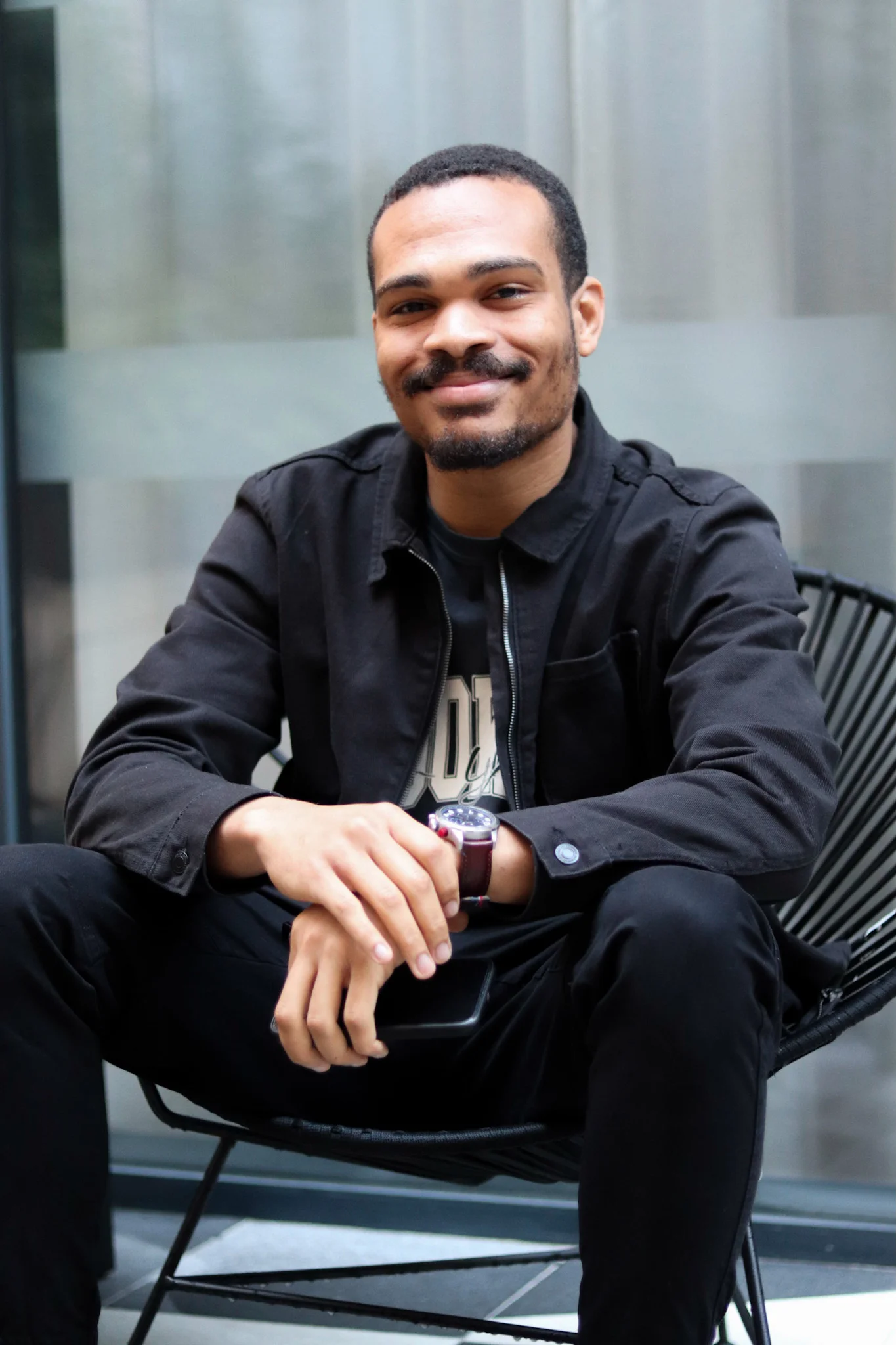 black guy seated and smiling
