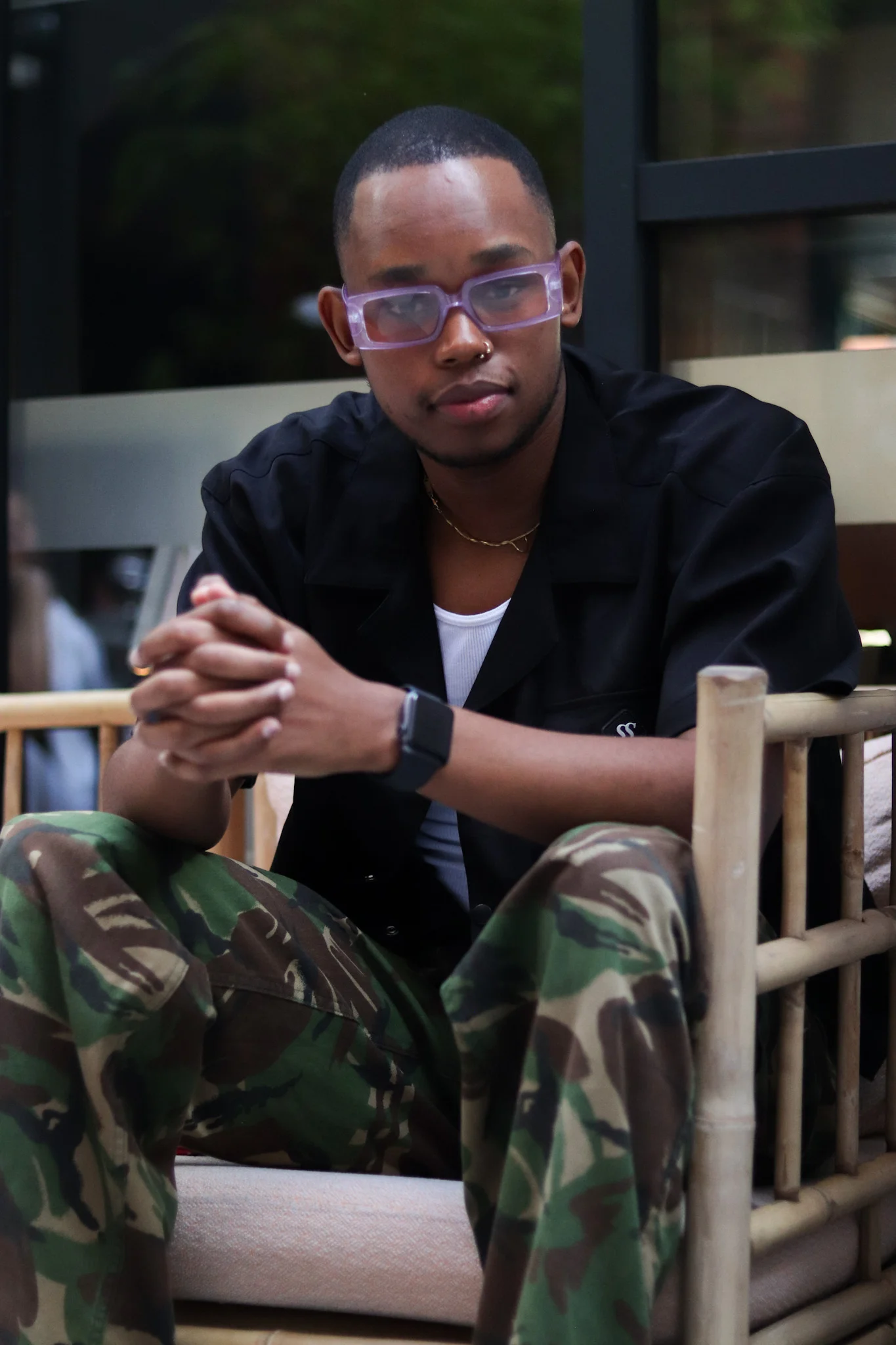 black gent with purple shades sitted
