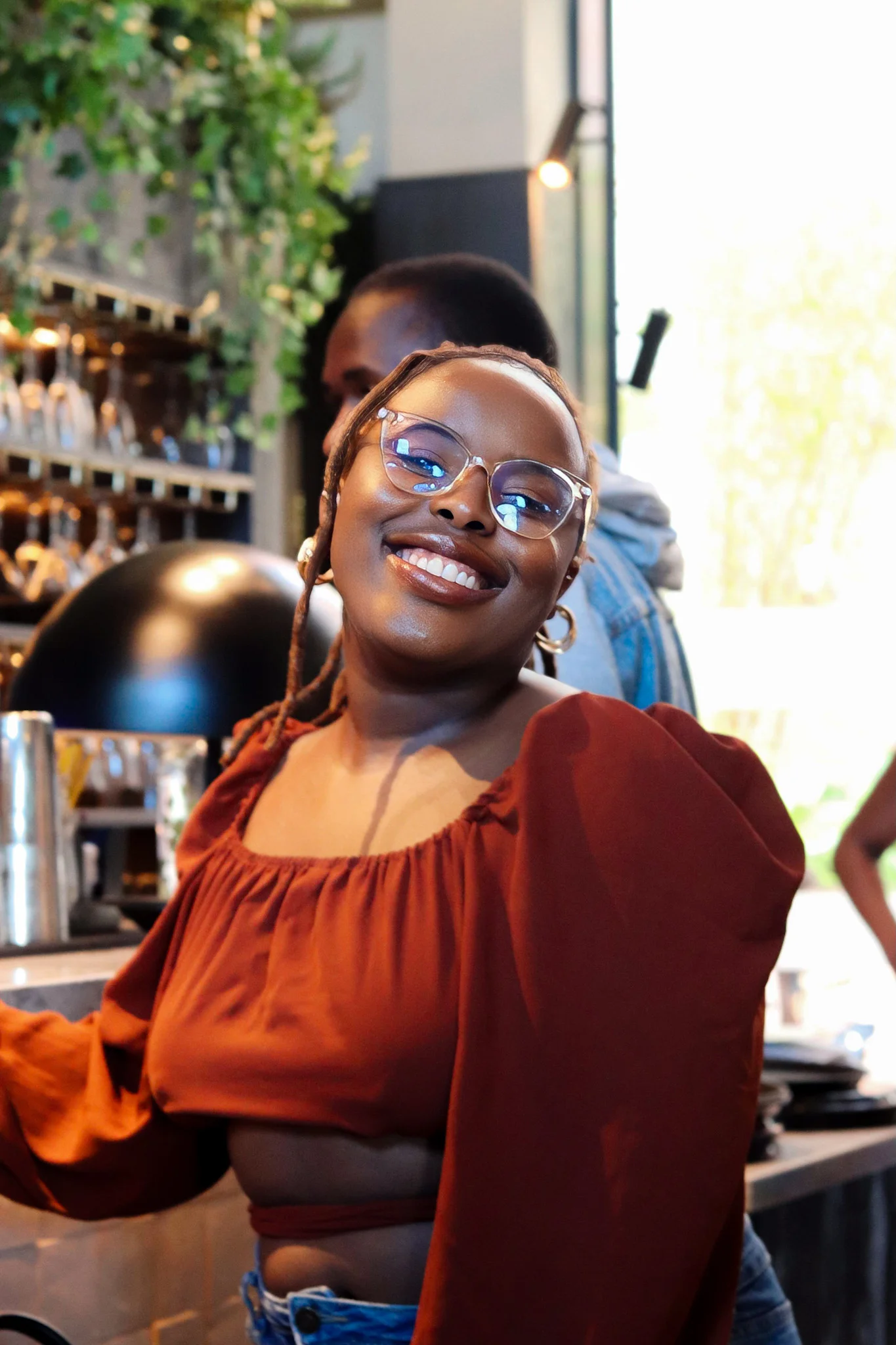 black girl standing by the bar and smiling