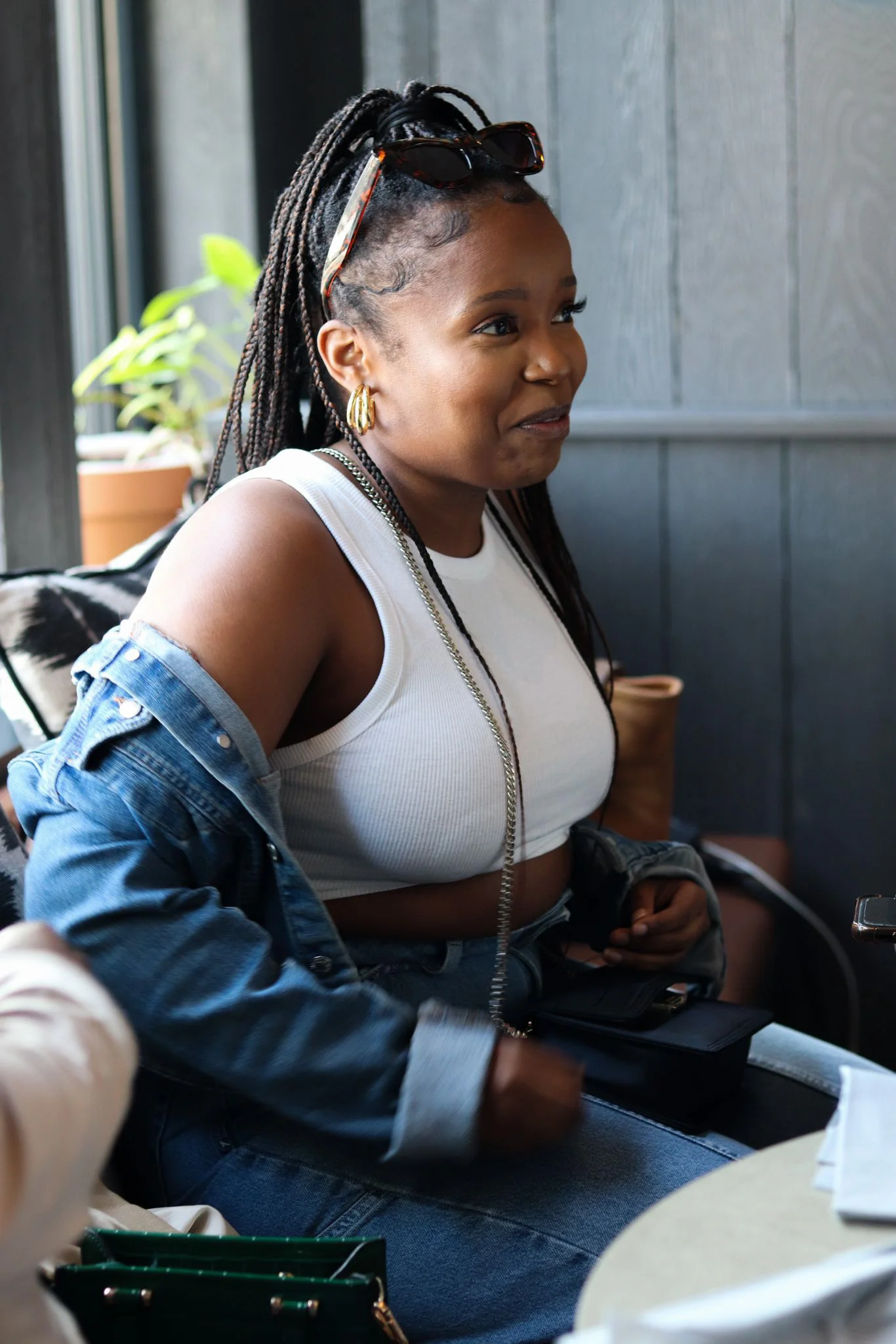 black girl seated inside a restuarnt