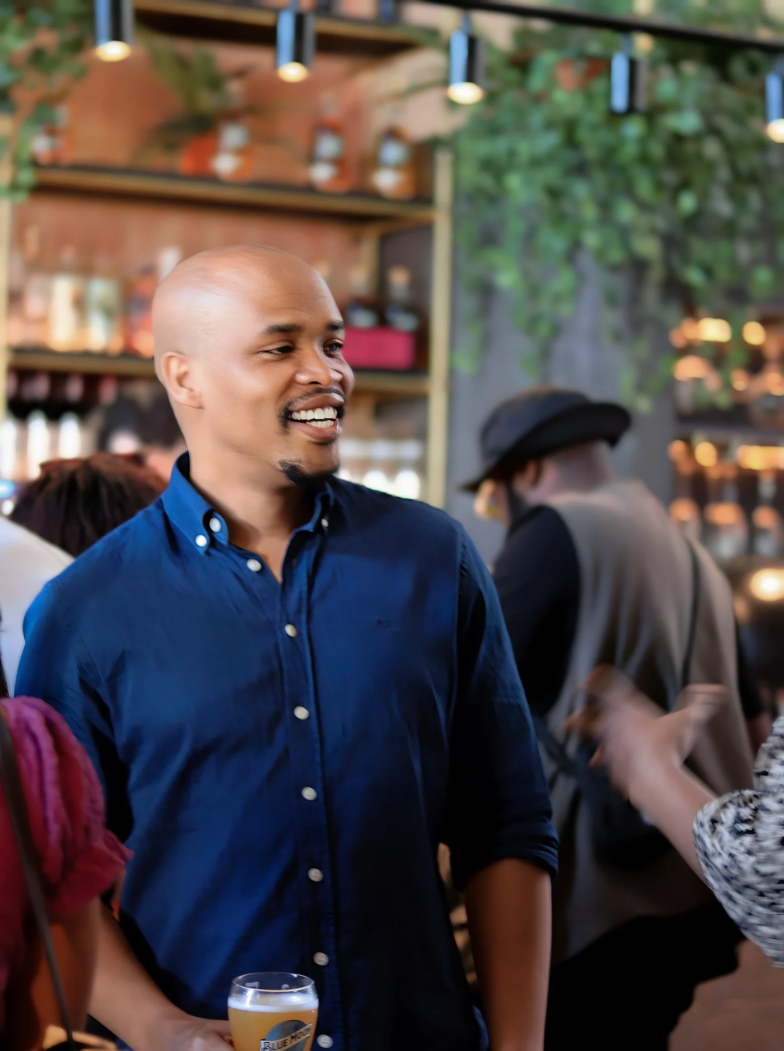 black guy smiling inside a restuarnt