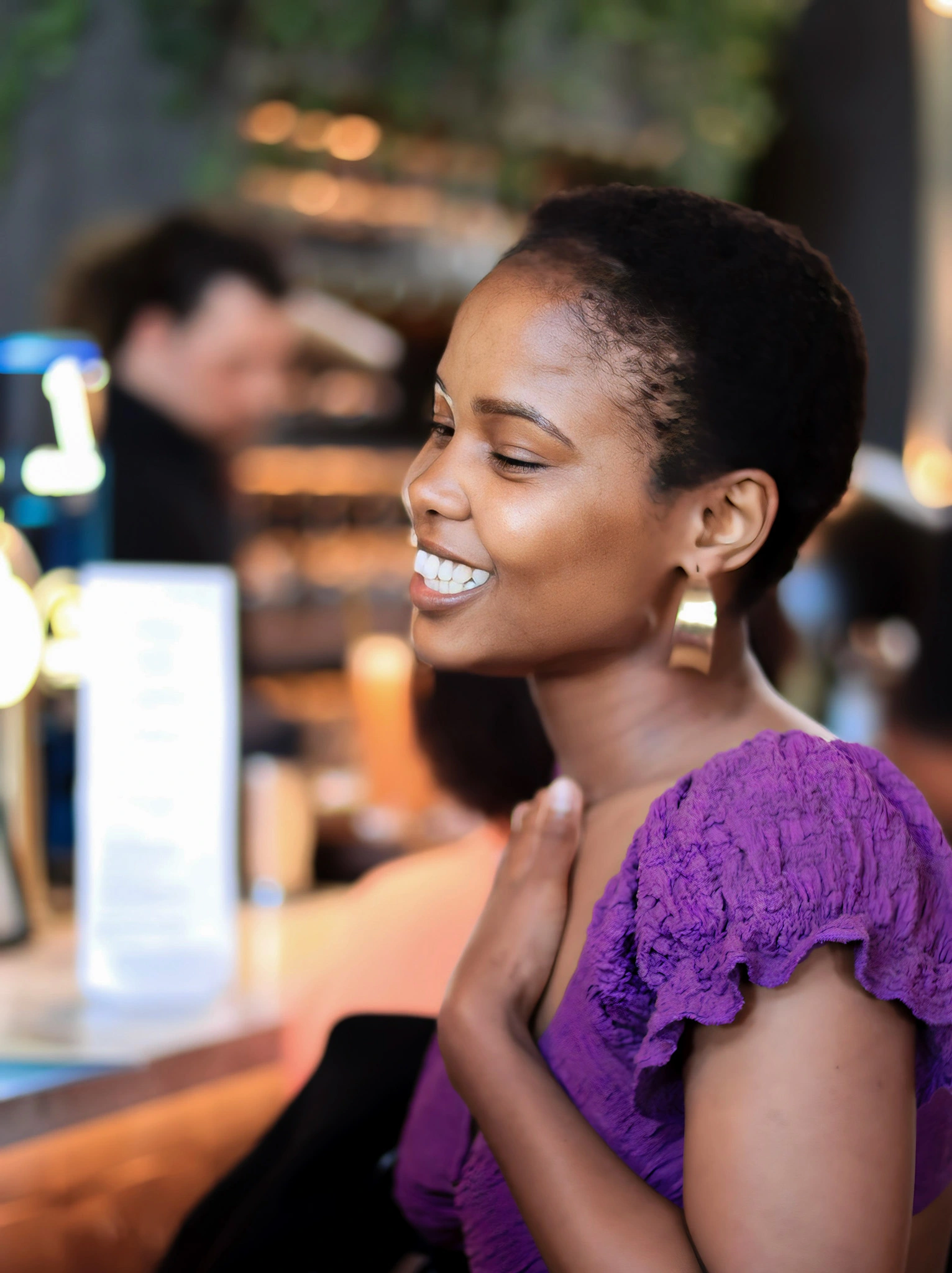 black girl in purple outfit smiling