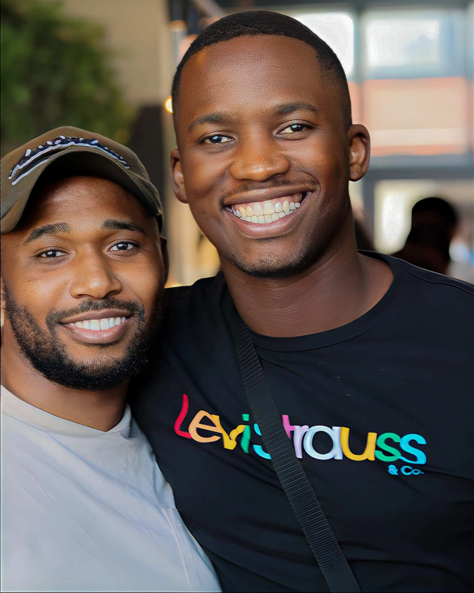 two black guys standing at the bar smiling